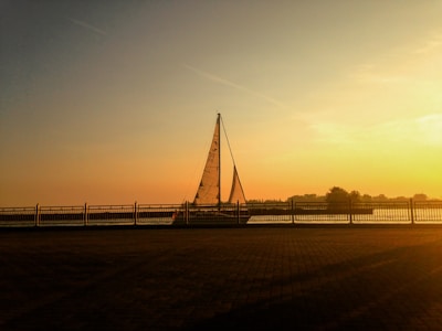 A sailboat glowing orange on Tampa Bay at sunset, reflecting the peaceful neighborhood vibe.