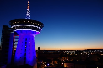 a tall tower with a blue light on top of it