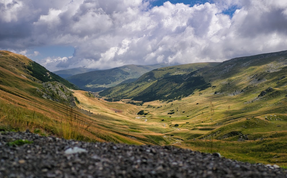 a view of a valley with mountains in the background