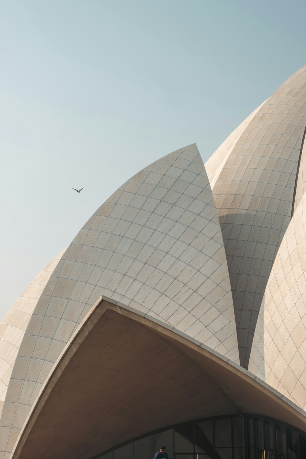 a large building with a plane flying over it