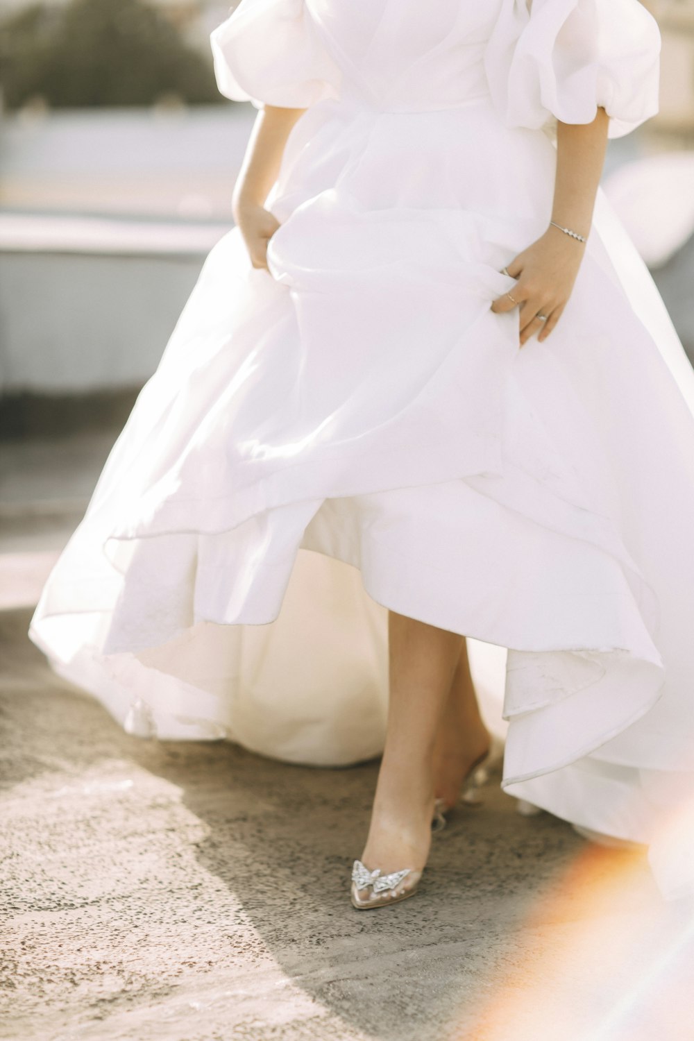 a woman in a white dress is posing for a picture