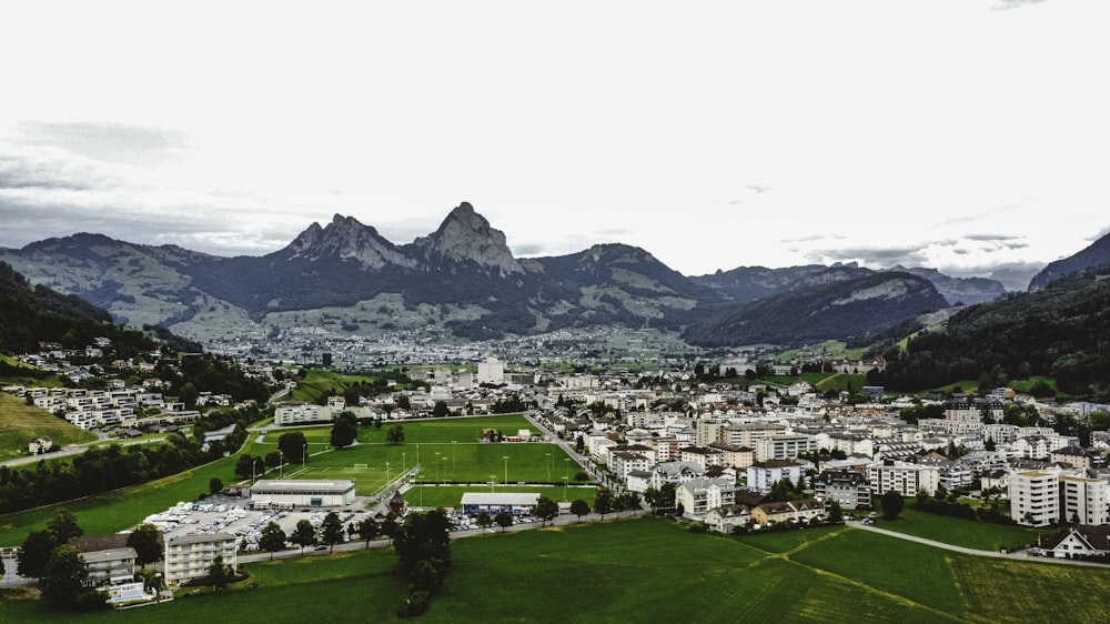 an aerial view of a city with mountains in the background