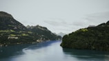A serene landscape with a tranquil river and mountains.