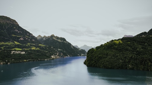 A serene landscape with a tranquil river and mountains.