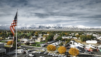a view of a town with a large american flag in the foreground