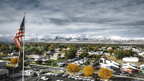 a view of a town with a large american flag in the foreground