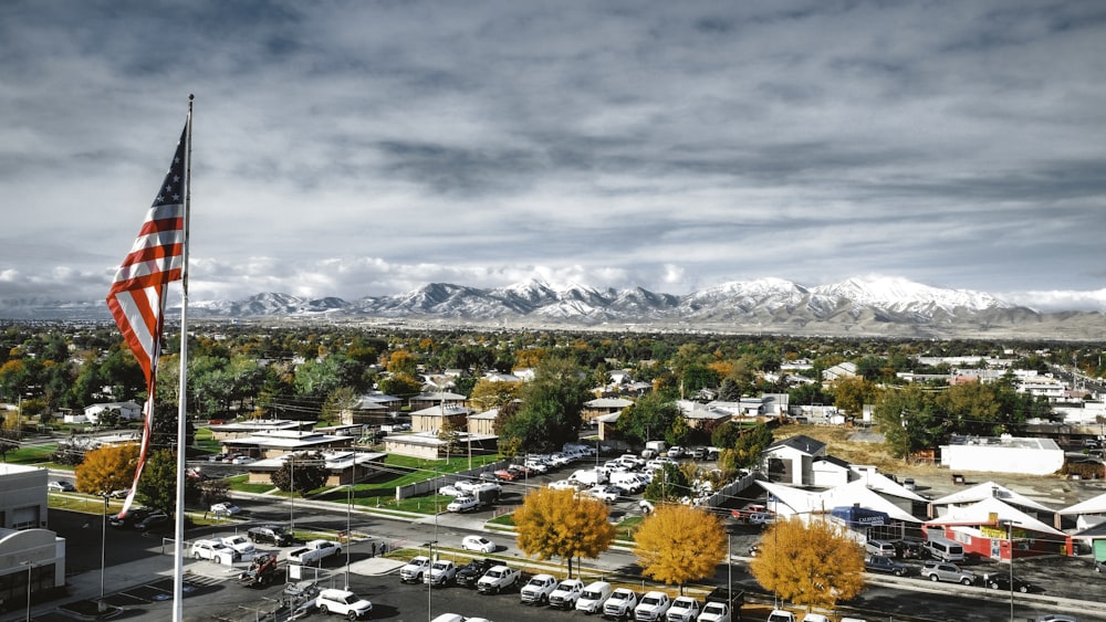 a view of a town with a large american flag in the foreground