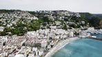 an aerial view of a city next to a body of water