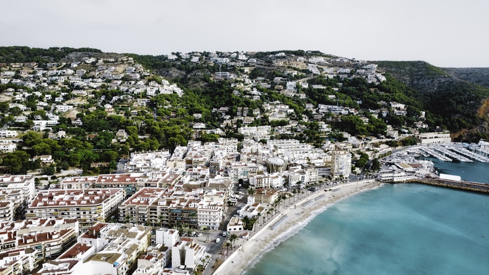 an aerial view of a city next to a body of water