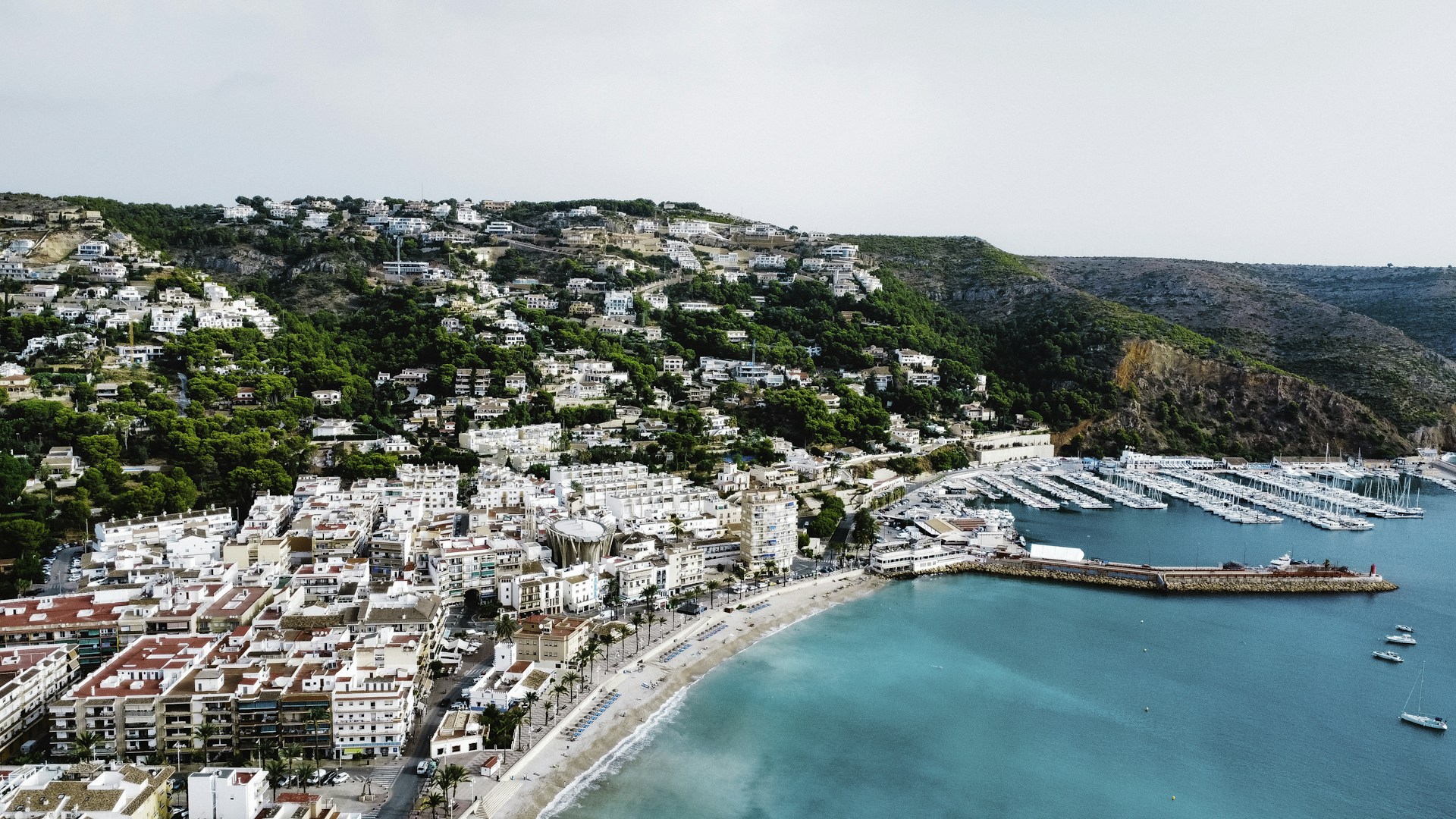 an aerial view of a city next to a body of water