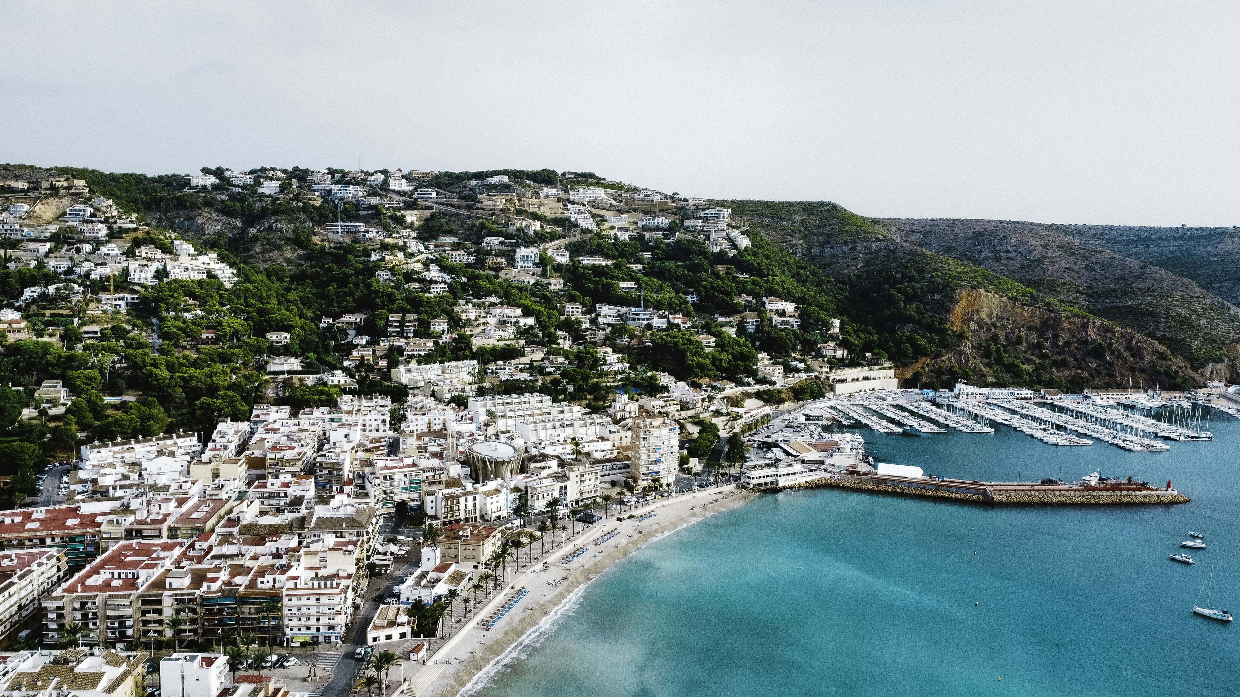 an aerial view of a city next to a body of water