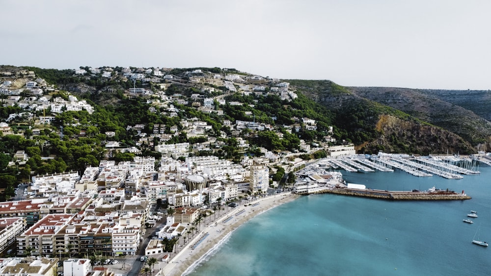 an aerial view of a city next to a body of water