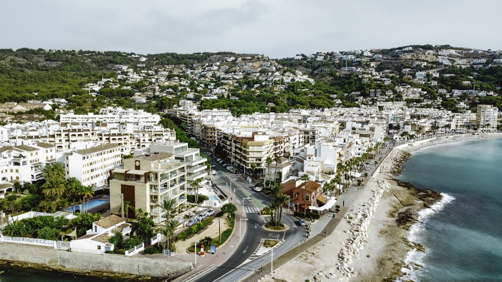 an aerial view of a city next to the ocean