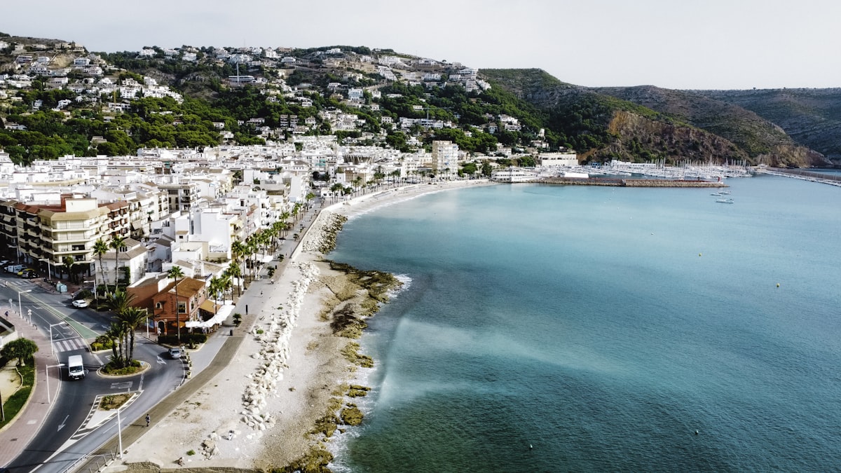 Mediterranean cove with white buildings and turquoise water in Jávea, Costa Blanca