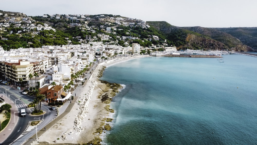 an aerial view of a city next to the ocean