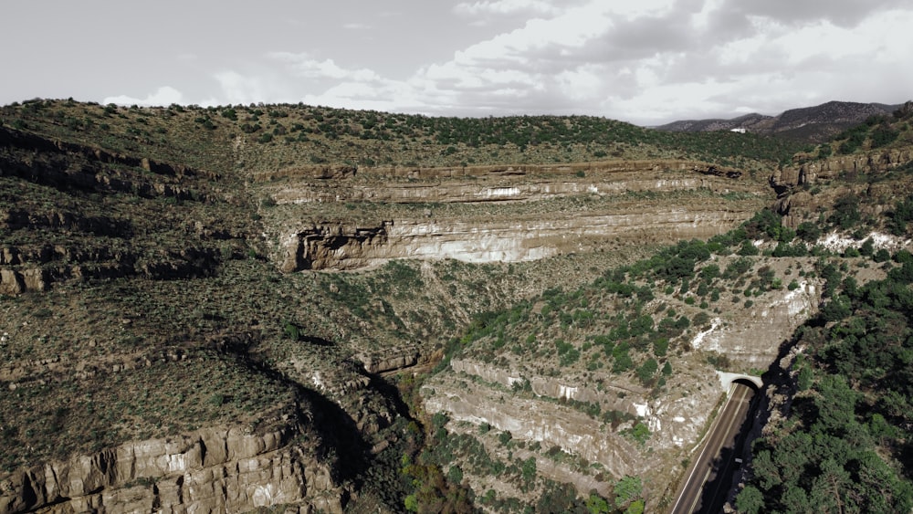 a view of a canyon with a train going through it