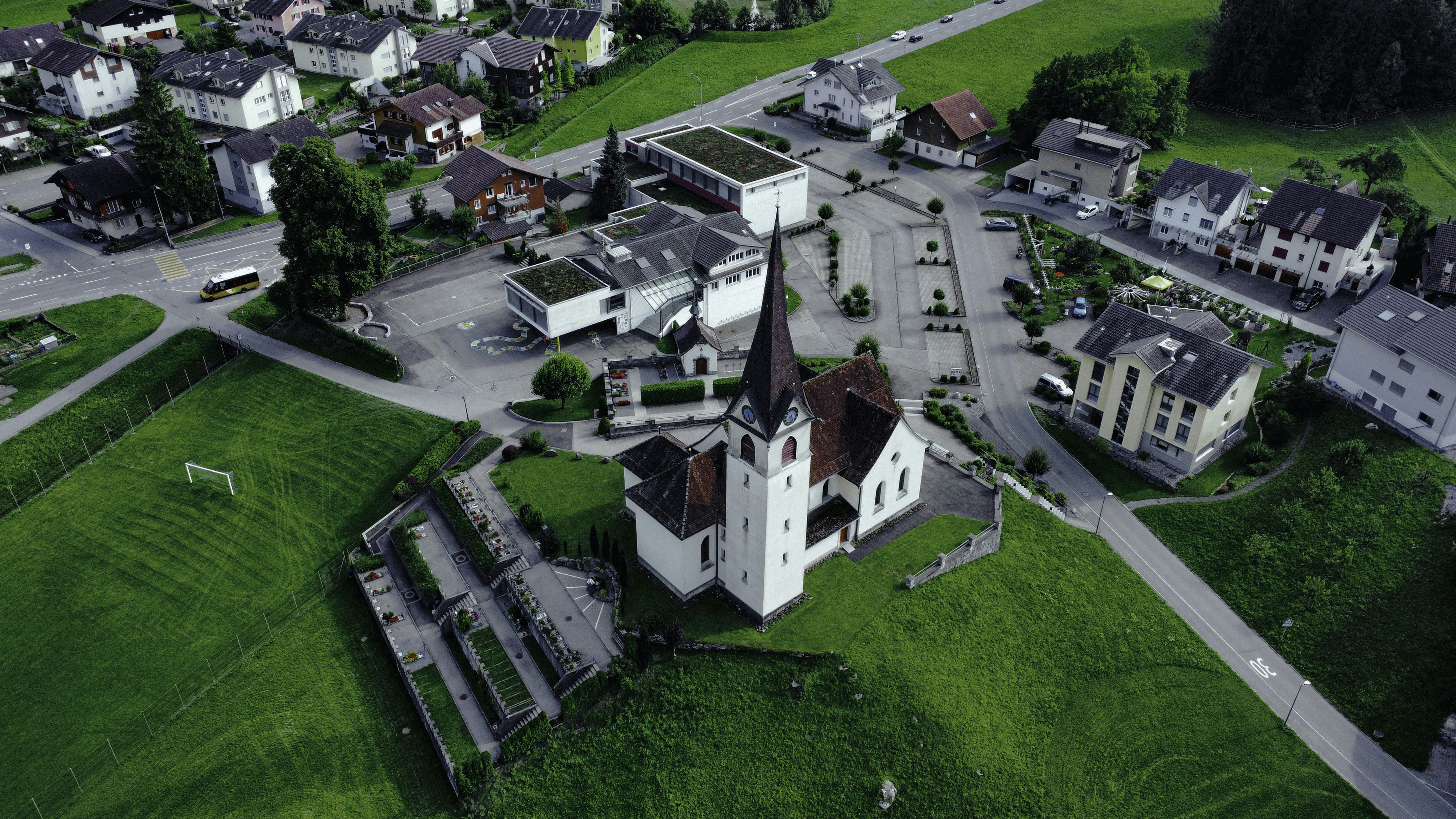 an aerial view of a small town with a church