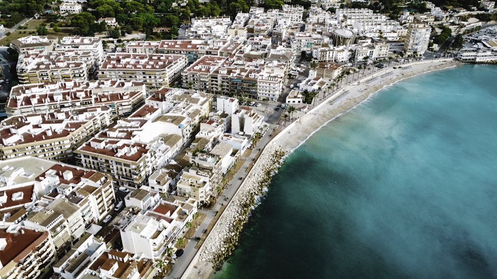 an aerial view of a city next to the ocean