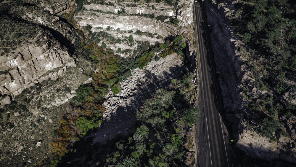 an aerial view of a road in the mountains