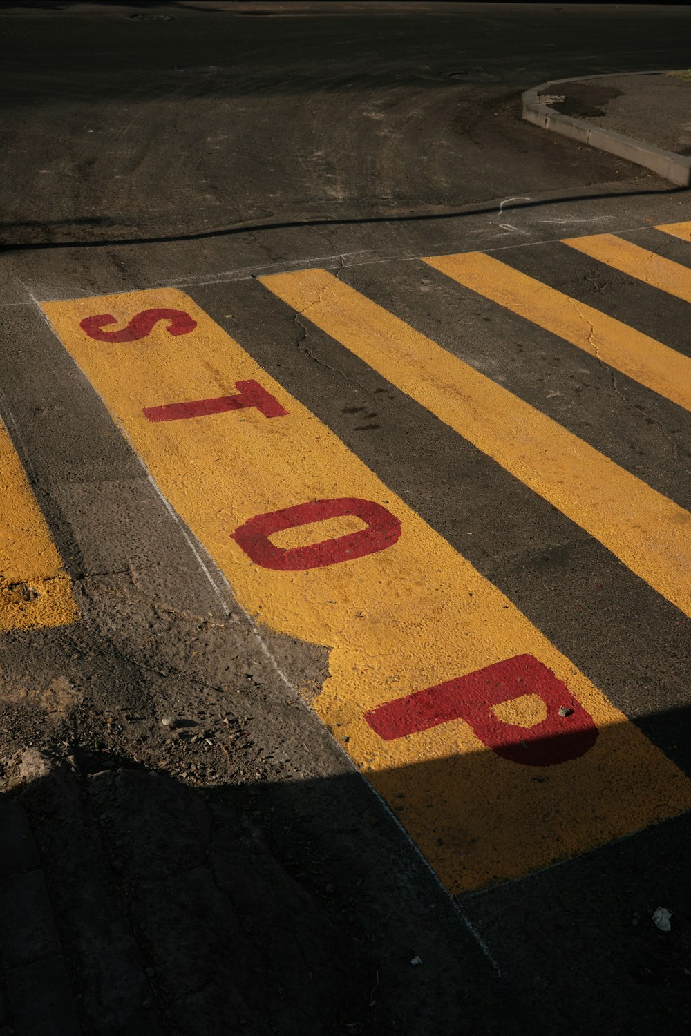 a parking lot with a stop sign painted on it