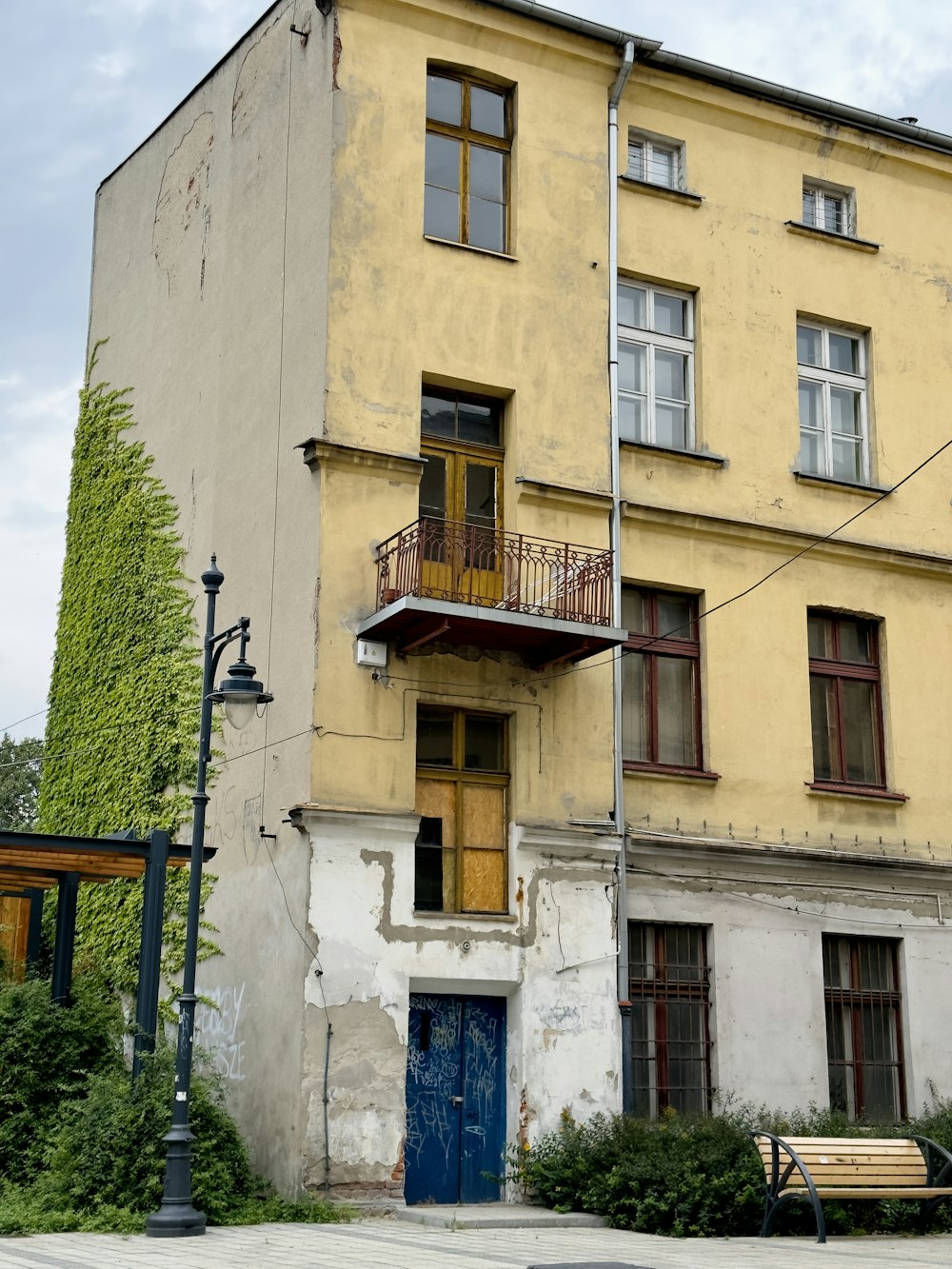 an old building with a blue door and balcony