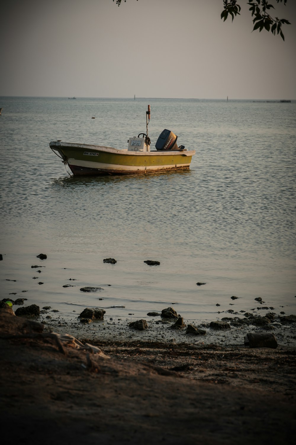 a small boat floating on top of a body of water