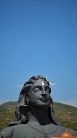 A peaceful figure meditating under a saffron sky with subtle cosmic patterns.