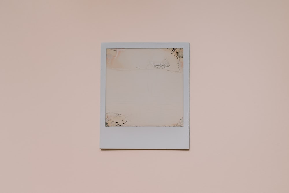 a white picture frame hanging on a wall