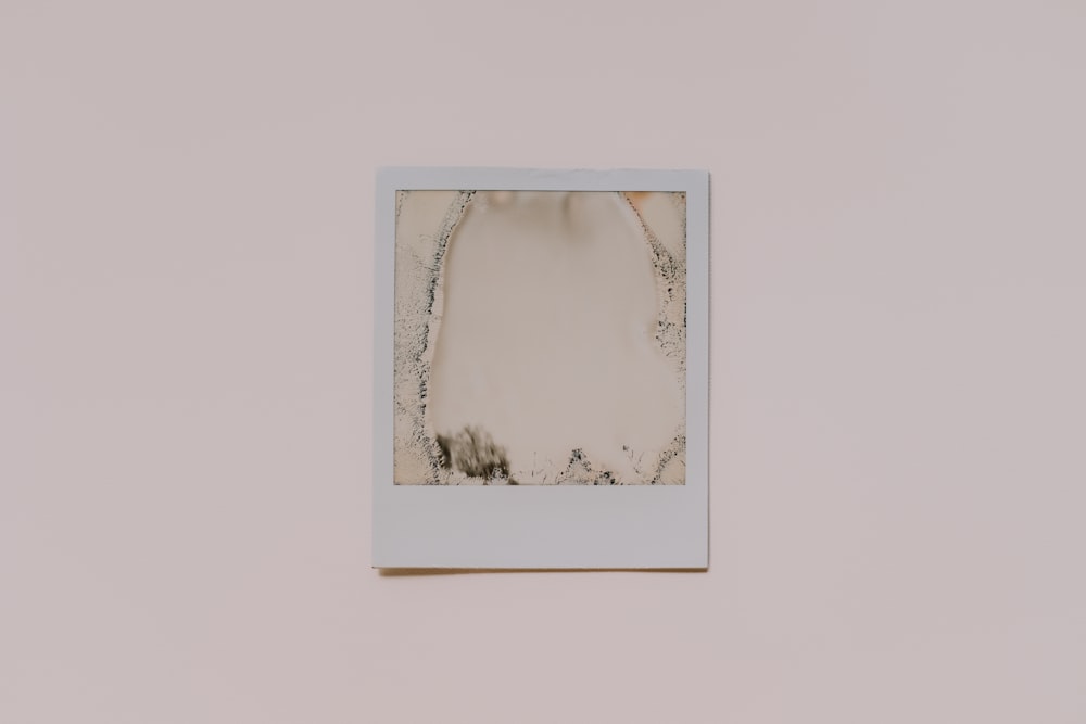 a white picture frame hanging on a wall