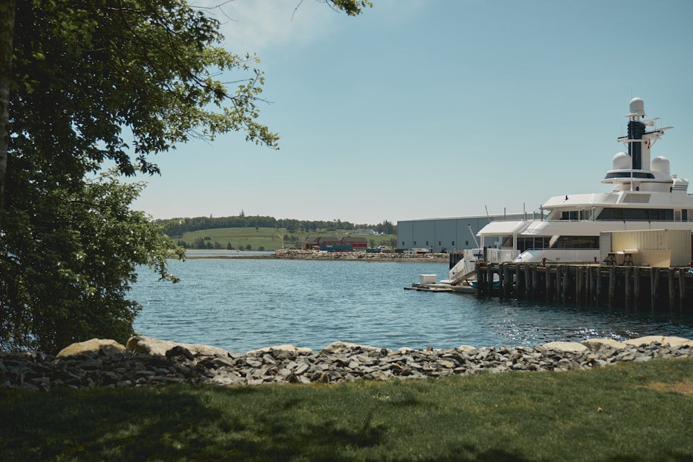 a large white boat docked at a dock