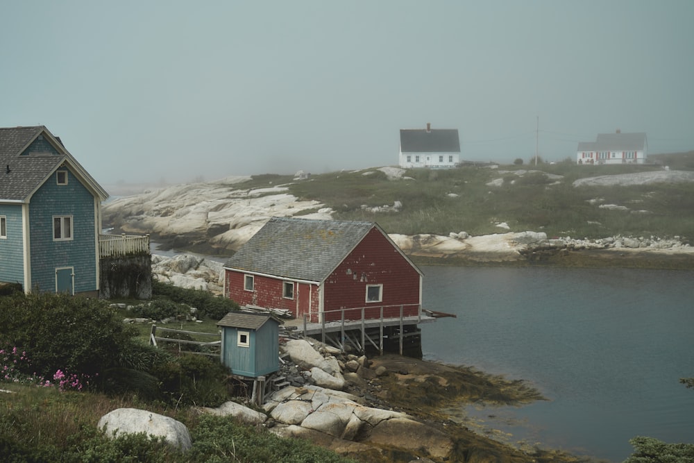 a couple of houses sitting next to a body of water