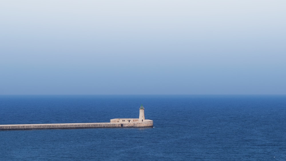 a lighthouse in the middle of a body of water