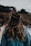 a woman with long hair walking on the beach