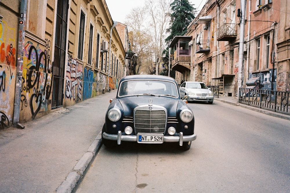 an old car parked on the side of a street