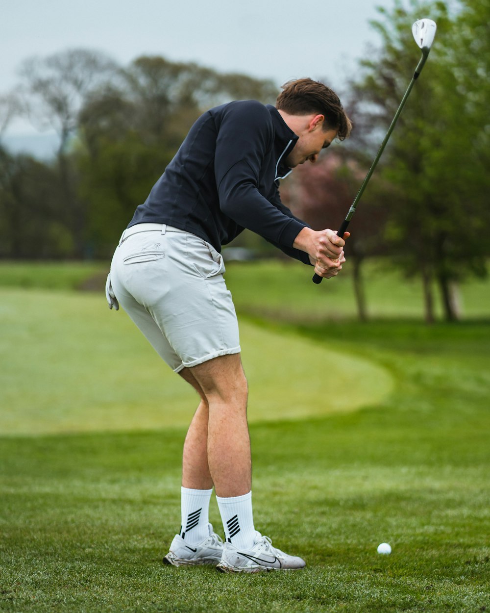 a man playing golf on a golf course