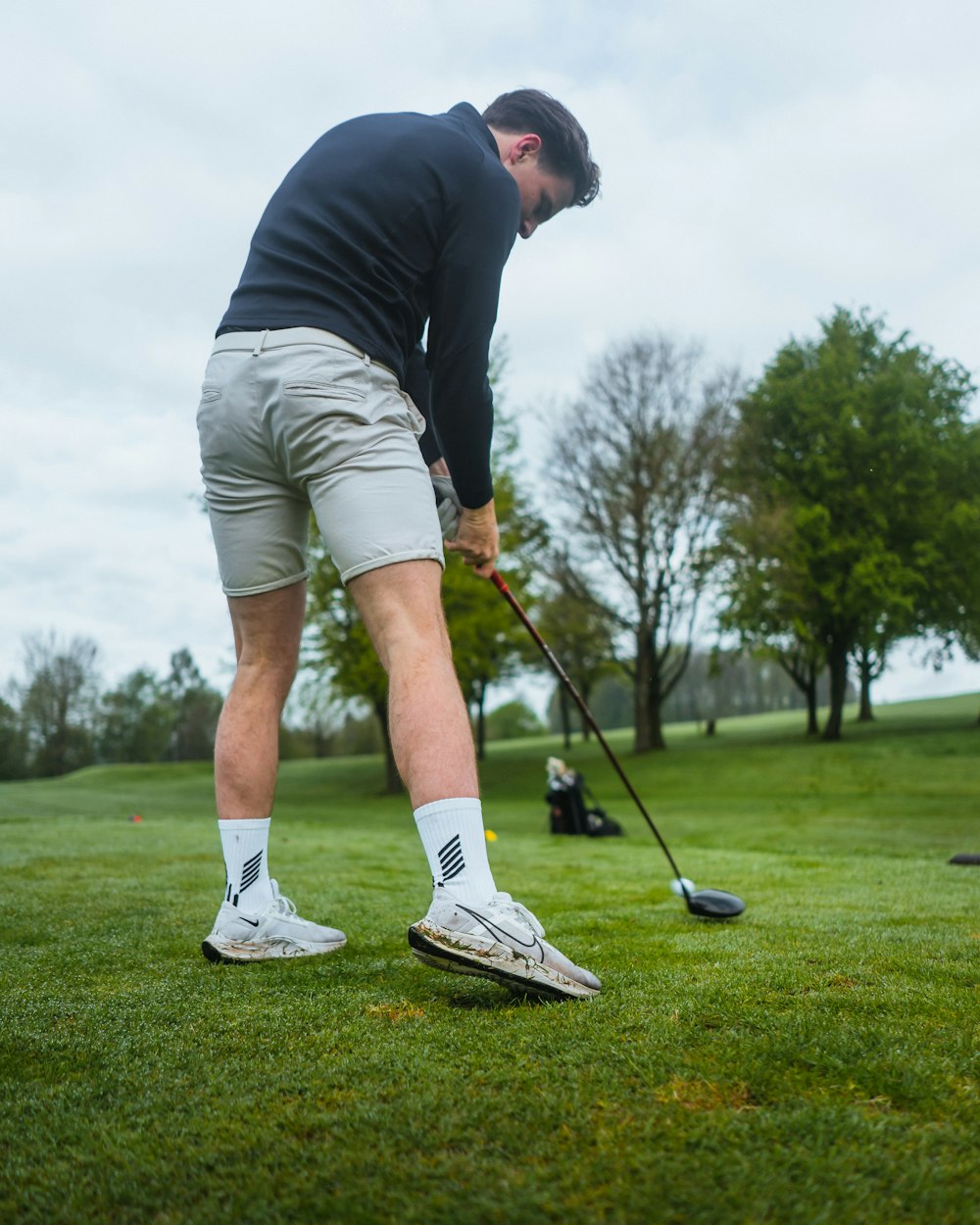 a man is playing golf on the grass