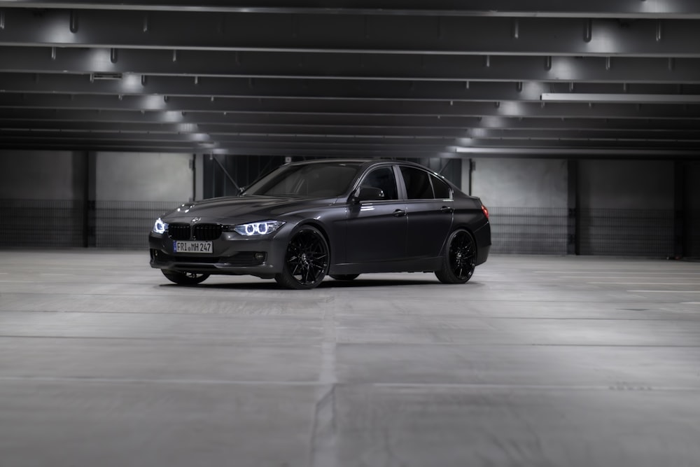 a black car parked in a parking garage