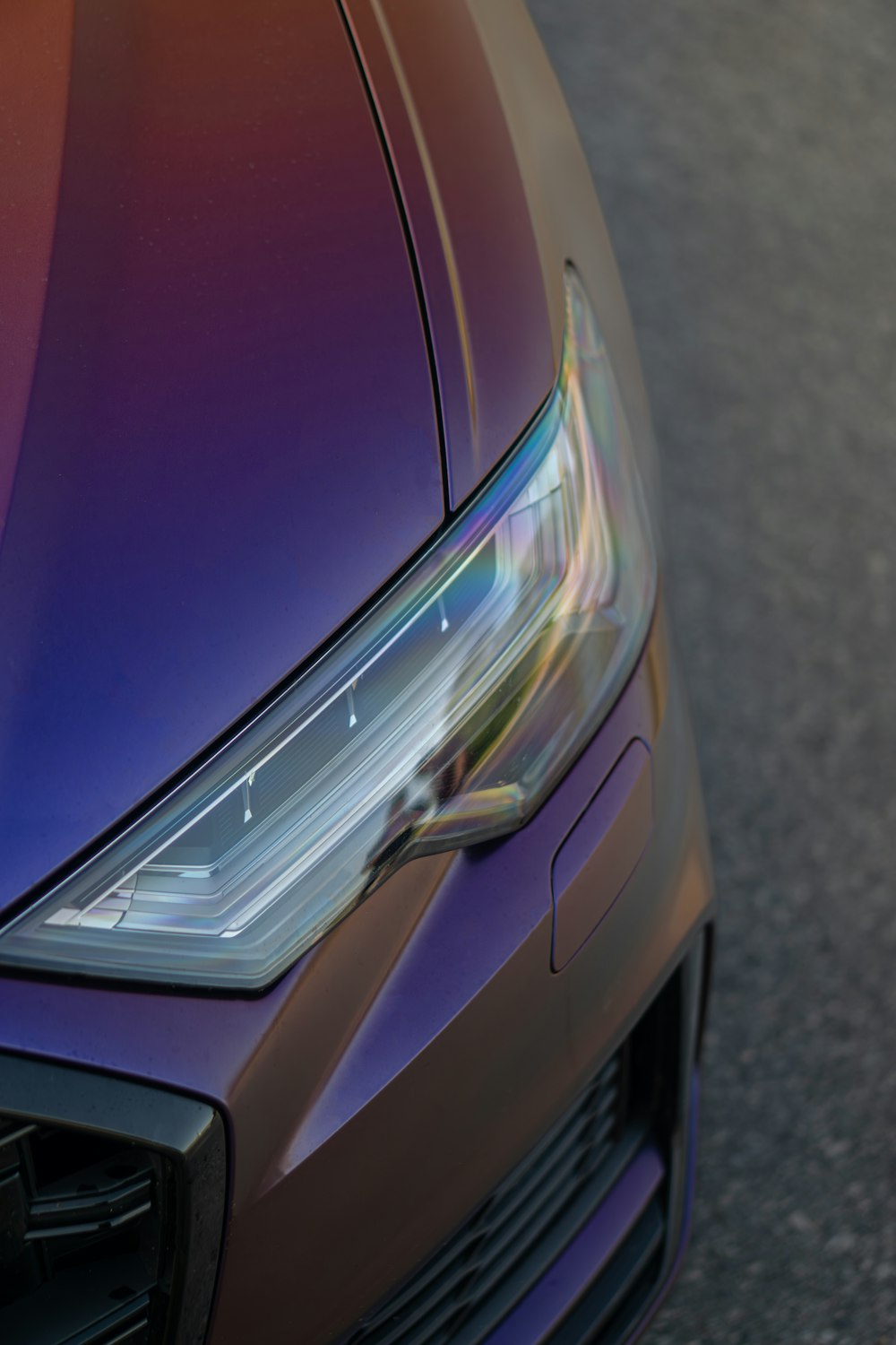 a close up of a car headlight on a street