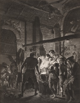 A group of people are gathered around a glowing furnace in what appears to be a blacksmith's workshop. The scene is set in a dimly lit space, with an arched stone wall, a thatched roof, and various tools and horses visible in the background. The interaction among the figures conveys a sense of focus and collaboration as they engage in crafting or metalwork.