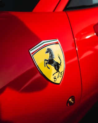 A detailed view of Ferrari's iconic logo on a car.