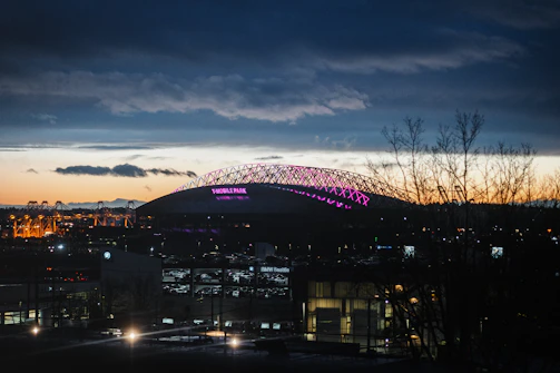 A night-time stadium lit up, symbolizing the excitement of transfer season.