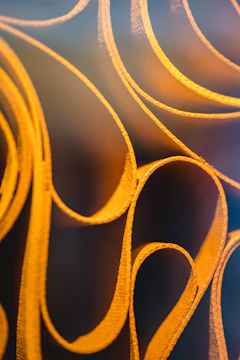 Golden lines subtly illuminating a dark textured background.