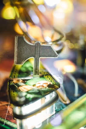Close-up of a vintage pinball machine with shiny metal details and flashing lights