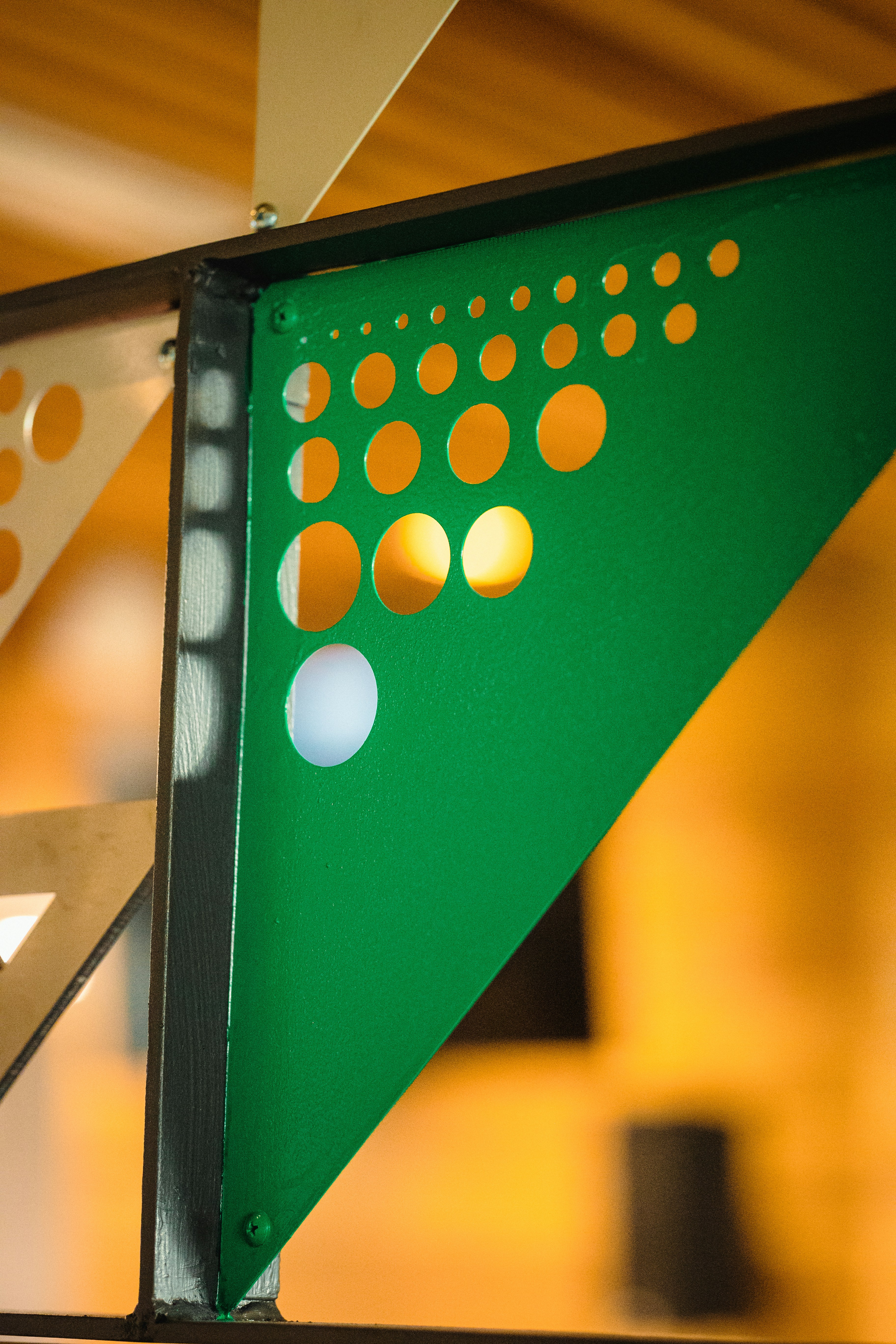 a close up of a green triangle with dots on it