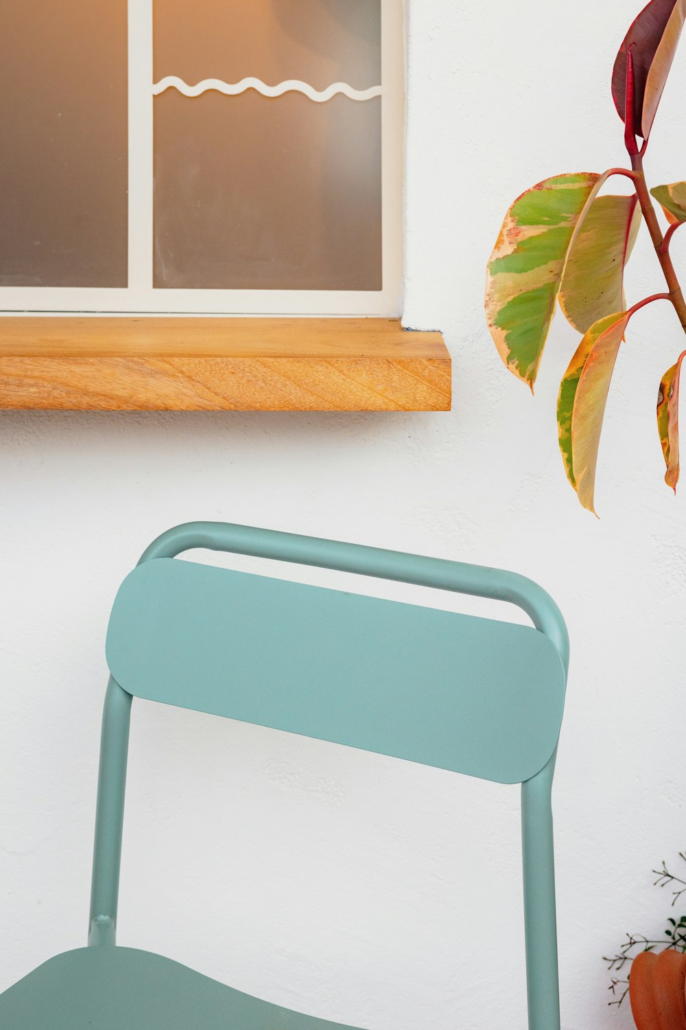 a blue chair sitting next to a window