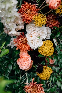 A vibrant flower arrangement with colorful roses and chrysanthemums