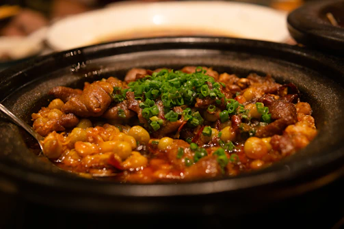 A steaming bowl of riz gras tiep sénégalais, rich with vegetables and tender meat.