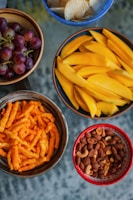 A vibrant assortment of flavored foxnuts in colorful bowls on a wooden table.