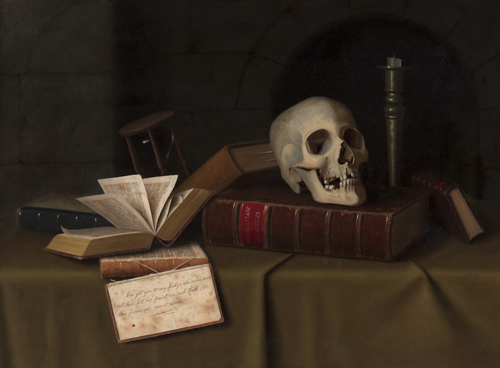 a painting of a skull and books on a table