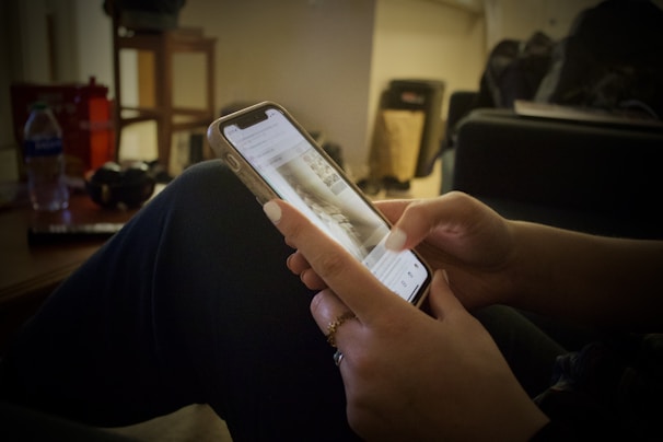 A focused person using the CortexAction app on their smartphone in a cozy workspace.